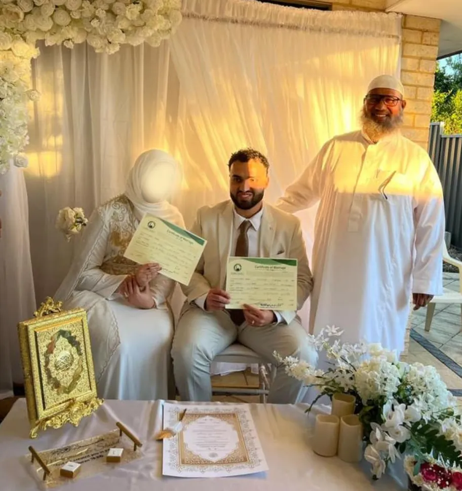 Sheikh Hisham Gad presenting official marriage certificate to bride and groom in Perth